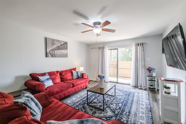 living room featuring wood-type flooring and ceiling fan