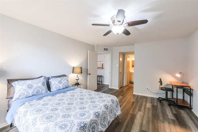 bedroom with ceiling fan, dark hardwood / wood-style floors, and ensuite bath