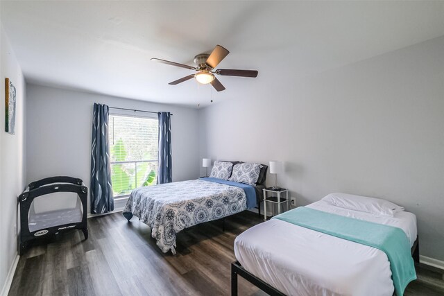 bedroom with ceiling fan and dark wood-type flooring