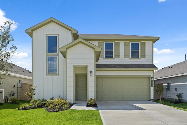 view of front of home with a garage and a front lawn