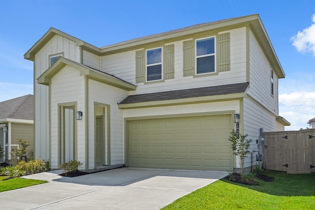 view of front of property with a garage and a front lawn