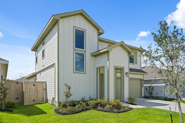 view of front of house with a garage and a front lawn