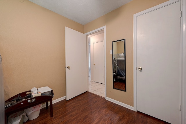 interior space featuring a textured ceiling and hardwood / wood-style floors