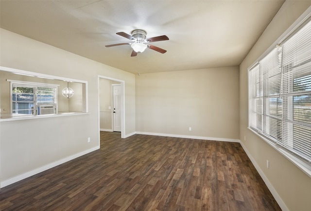 spare room featuring ceiling fan with notable chandelier, cooling unit, and dark hardwood / wood-style floors