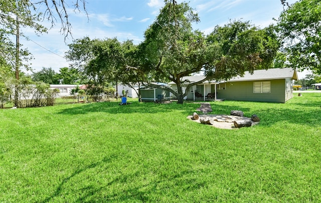 view of yard with a fire pit