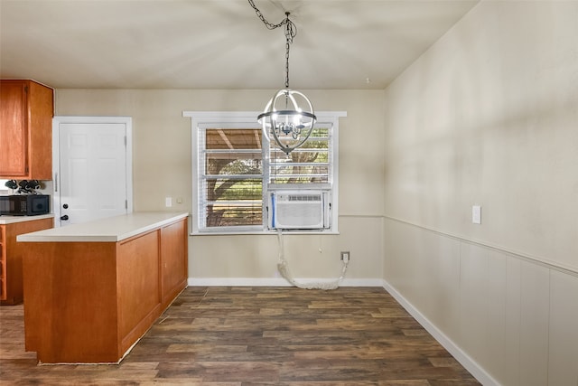 kitchen with kitchen peninsula, cooling unit, decorative light fixtures, dark hardwood / wood-style floors, and a chandelier