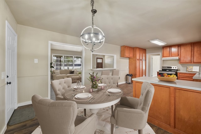 dining space featuring a notable chandelier and dark hardwood / wood-style floors