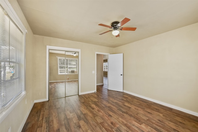 unfurnished bedroom with ceiling fan, a closet, and dark wood-type flooring