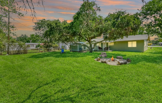 yard at dusk with an outdoor fire pit