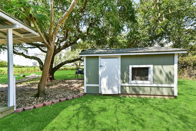 view of outbuilding featuring a yard