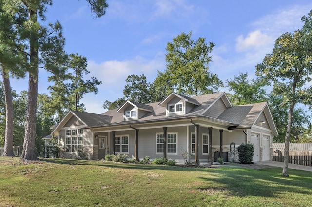 view of front facade featuring a garage, a porch, and a front lawn