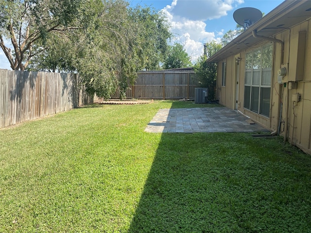 view of yard with a patio and central AC