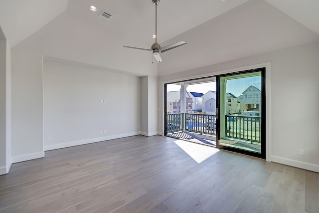 empty room featuring light wood-type flooring, vaulted ceiling, and ceiling fan