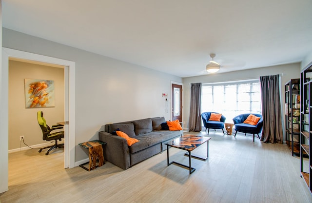 living room with light wood-type flooring and ceiling fan