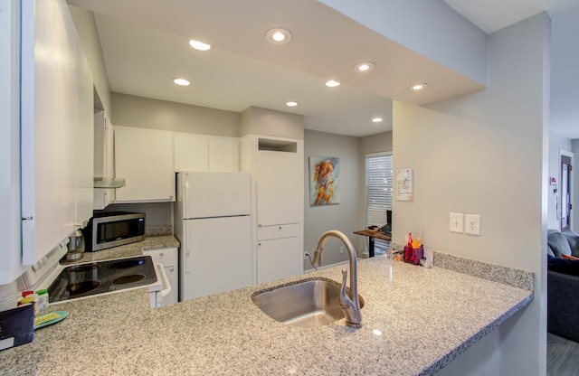 kitchen featuring sink, range, kitchen peninsula, white cabinets, and white refrigerator