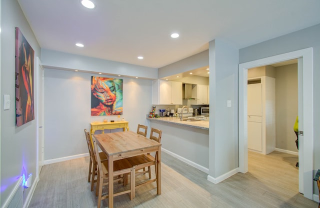 dining area featuring light hardwood / wood-style flooring and sink