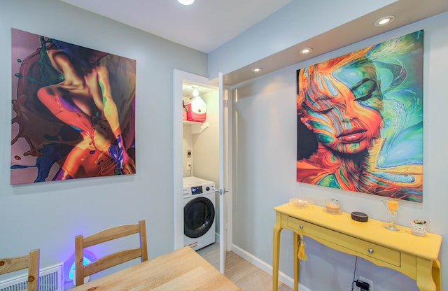 washroom with washer / dryer and light hardwood / wood-style floors