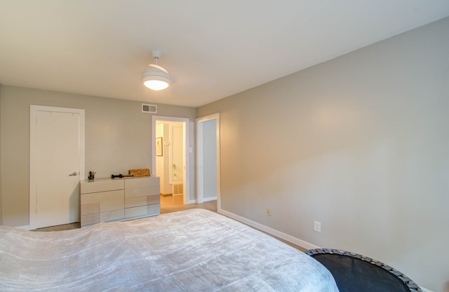 bedroom with ensuite bathroom and ceiling fan