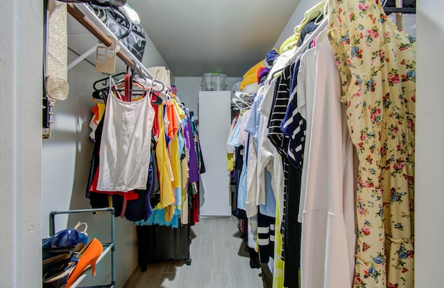 spacious closet with light hardwood / wood-style floors