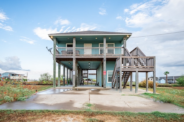 back of house featuring a carport and a porch