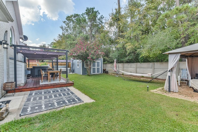 view of yard featuring a deck, a pergola, a hot tub, and a shed