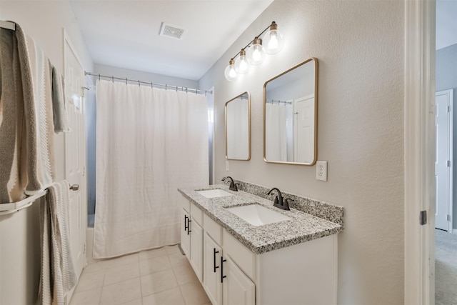 bathroom featuring tile patterned flooring, vanity, and shower / bath combination with curtain