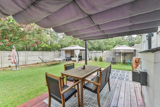 wooden terrace with a gazebo and a lawn