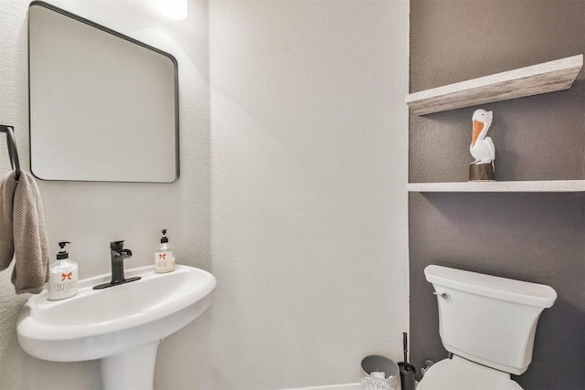 bathroom featuring toilet and sink