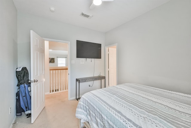 bedroom with ceiling fan and light carpet