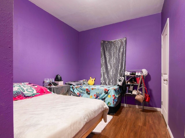 bedroom with hardwood / wood-style flooring