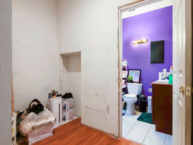 bathroom featuring vanity, hardwood / wood-style flooring, and toilet