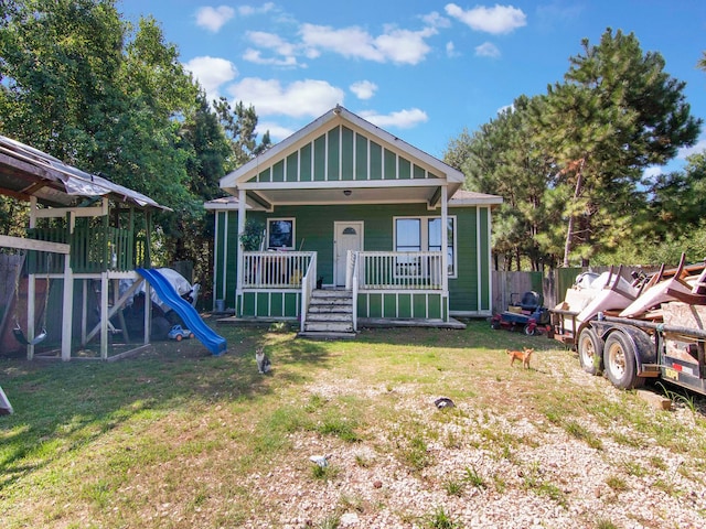 exterior space featuring a playground, a yard, and covered porch