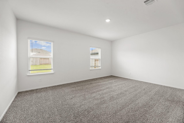 carpeted spare room with visible vents, recessed lighting, and baseboards