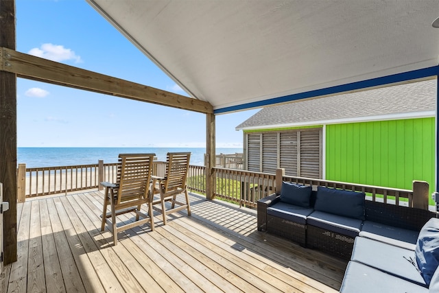 wooden terrace with a water view and an outdoor hangout area