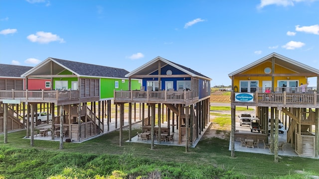 view of jungle gym featuring a yard, a deck, and a patio area