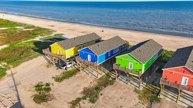 drone / aerial view with a water view and a beach view