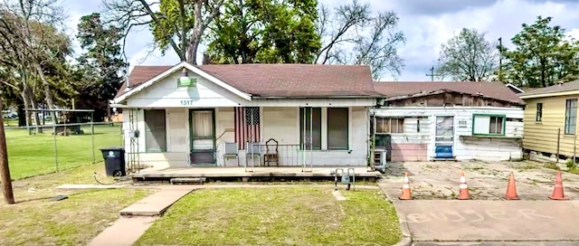 exterior space featuring a lawn and a porch