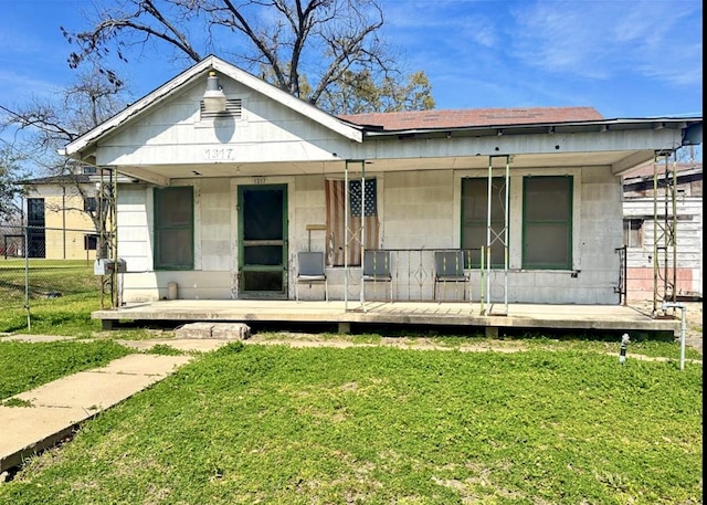 1317 Moody St, Houston, TX 77009 - view of front of home featuring a front lawn, a porch, and a shingled roof