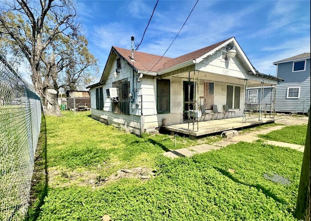 1317 Moody St, Houston, TX 77009 - rear view of house with fence, a yard, and a shingled roof