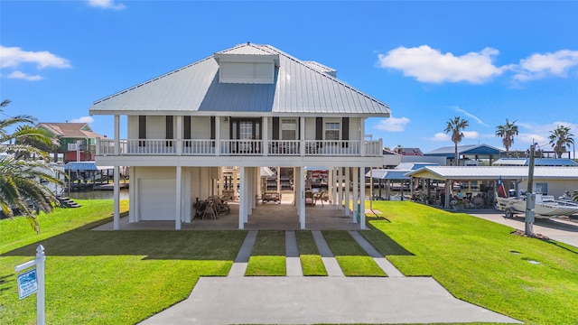 back of property with a yard, a garage, and a porch