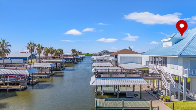 view of dock with a balcony and a water view