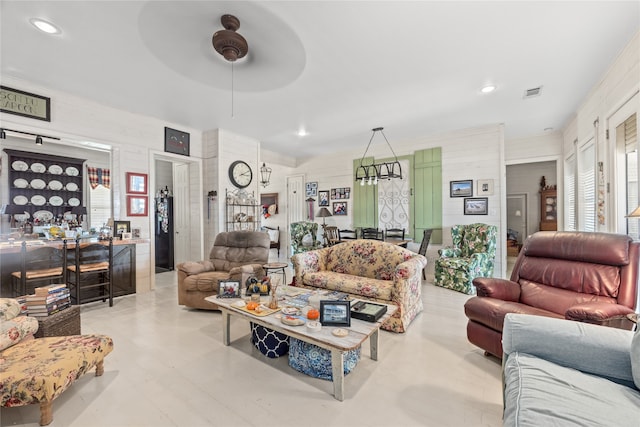 living room featuring ceiling fan and a healthy amount of sunlight