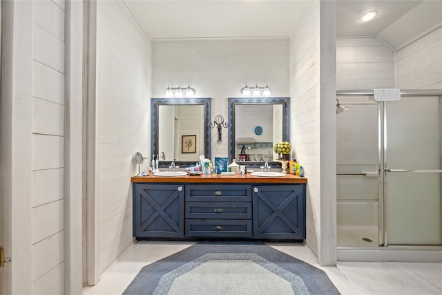 bathroom with wooden walls, lofted ceiling, vanity, and a shower with door