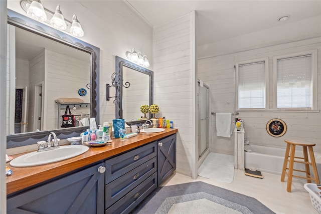 bathroom featuring vanity, shower with separate bathtub, and wooden walls