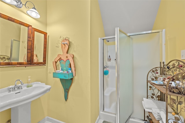 bathroom featuring walk in shower and sink