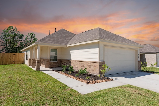 ranch-style house with a yard and a garage