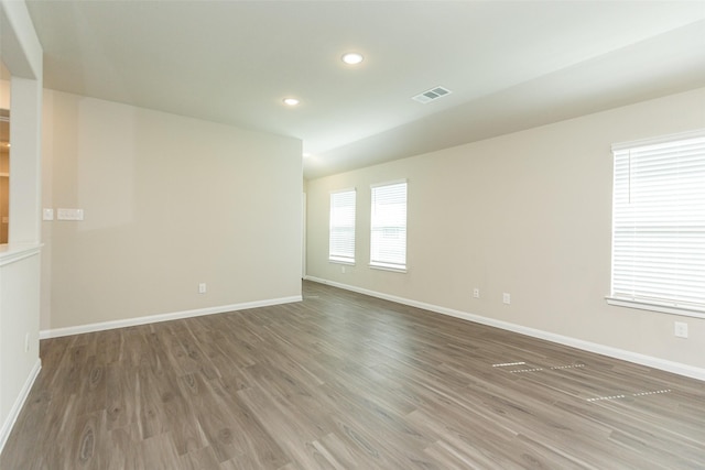 unfurnished room featuring hardwood / wood-style floors and a healthy amount of sunlight