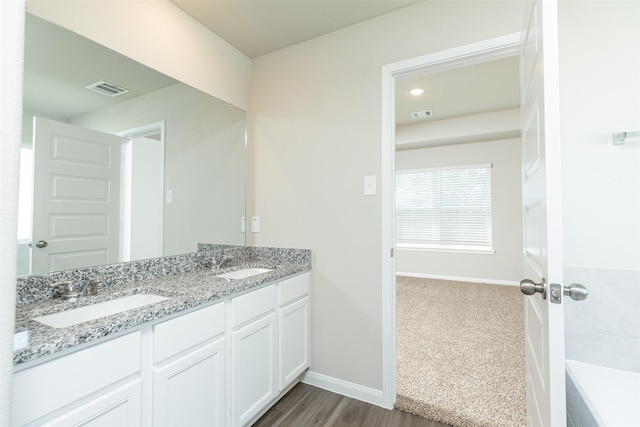 bathroom featuring hardwood / wood-style floors and vanity