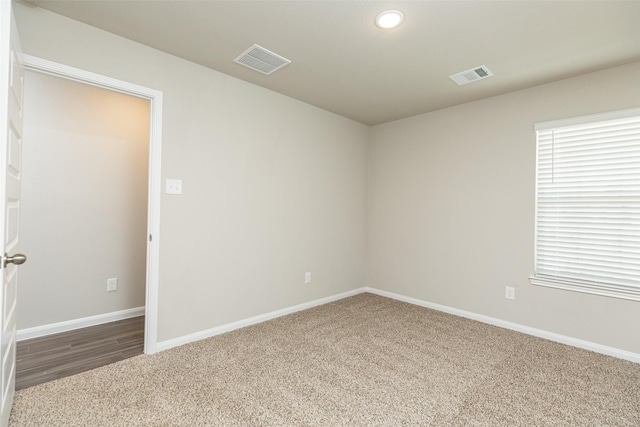 empty room with dark carpet