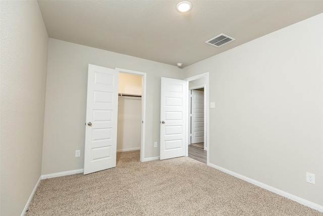 unfurnished bedroom with carpet flooring and a closet